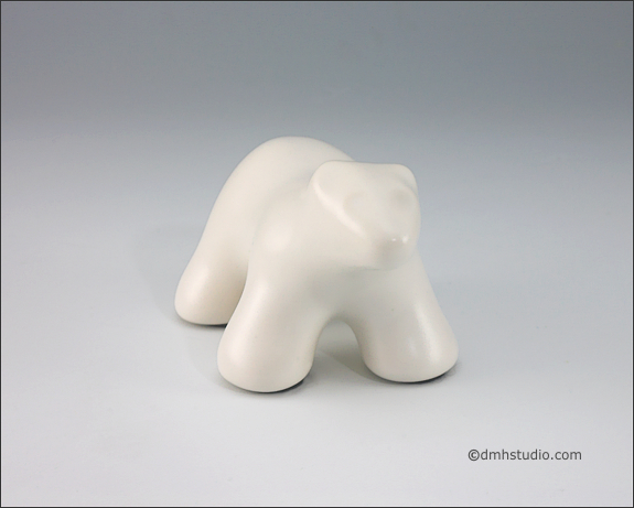 Large image of baby polar bear sculpture in carrara white, portrait facing out.