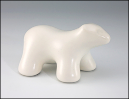 Image of baby polar bear sculpture in carrara white, profile facing the viewers right.