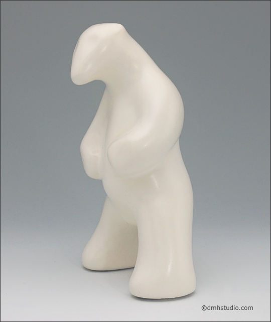 Large image of standing white polar bear sculpture, profile facing to the viewers left.