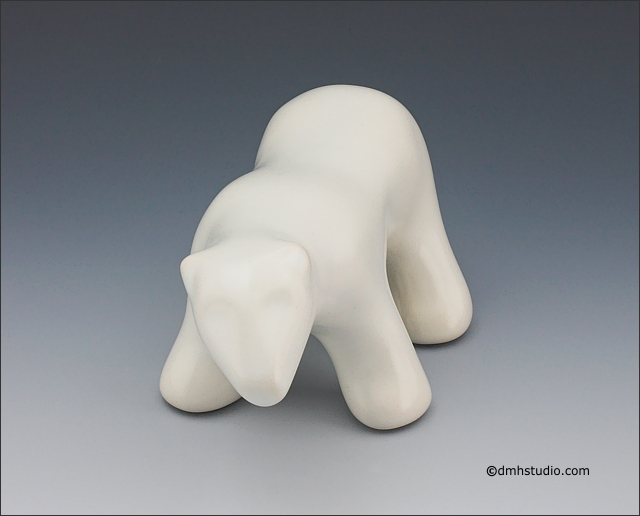 Large image of waking polar bear sculpture in carrara white, portrait facing out.