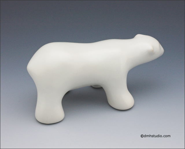Large image of walking polar bear sculpture in carrara white, profile facing right.