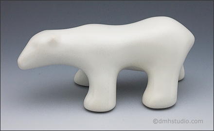 Image of walking polar bear sculpture in Carrara White, profile facing left.