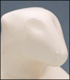 Close-up image of mother polar bear sculpture's face, facing the viewers right.