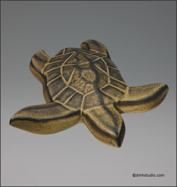 Large image of Hanalei Sea Turtle sculpture in black gold glaze, seen  from slightly above, and facing a bit to the viewers right.
